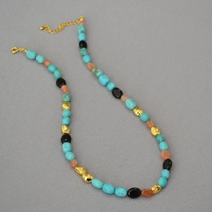 Detail of baroque turquoise beaded necklace with gold extension chain and spring clasp