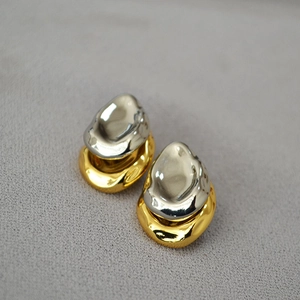 Irregular heart shaped stud earrings with silver and gold finish in lava style