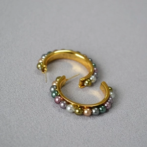 French vintage C-shaped gold hoop earrings with multi-colored pearls in a 45-degree view