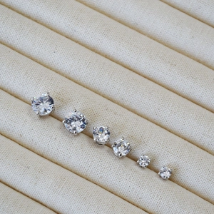 Set of six round cubic zirconia stud earrings in varied sizes with silver claw setting