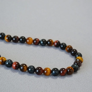 Maillard style tiger eye stone beaded necklace with vintage gold, red and blue hues