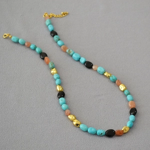 Detail of baroque turquoise beaded necklace with gold accents and lobster clasp