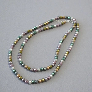 Detailed view of colorful faux pearl necklace with olive green beads and lobster clasp