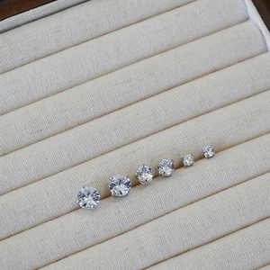 Close-up of six round-cut cubic zirconia stud earrings in varying sizes with four-prong setting