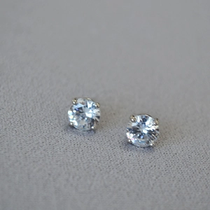 Close-up of classic four-prong setting cubic zirconia stud earrings in silver finish