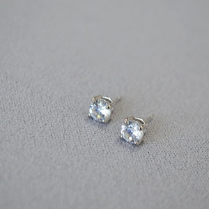 S925 sterling silver stud earrings featuring four-prong set sparkling round cubic zirconia