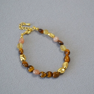 Close-up of tiger eye and colorful beads with adjustable gold lobster clasp chain