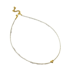 Minimalist pearl necklace featuring a delicate gold heart pendant and adjustable clasp