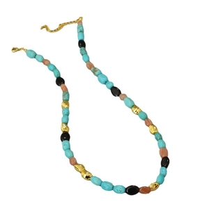 Vintage baroque turquoise beaded necklace with gold accents and orange stones on white background