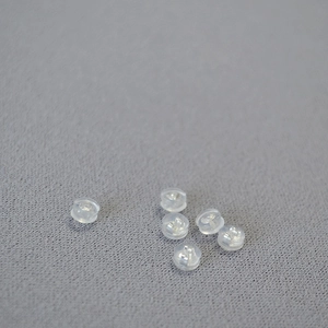 Macro detail of transparent silicone earring backs with 925 silver metal cores