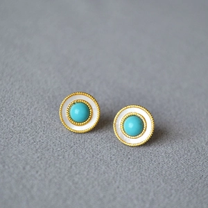 Detailed view of vintage gold stud earrings with turquoise center and shell inlay border