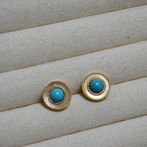 Detail of vintage round stud earrings with white mother-of-pearl and turquoise bead trim