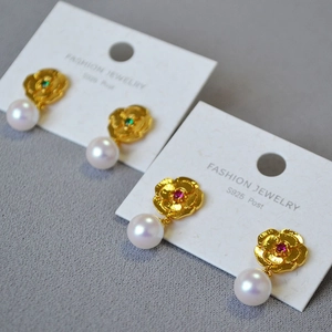 Detail of vintage flower earrings with pearls, colorful gems and S925 silver posts