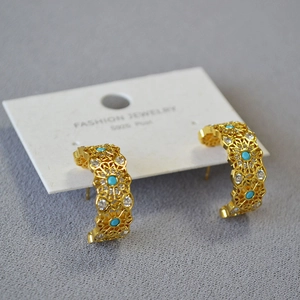 Detail of vintage gold C-shape floral earrings with turquoise beads and S925 silver posts
