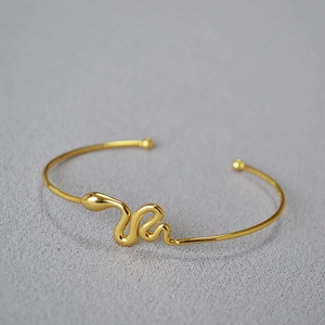 Minimalist gold-plated snake-shaped open bracelet with a polished finish for women