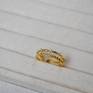 Macro detail of gold-plated double layer ring featuring sparkling micro-pave cubic zirconia