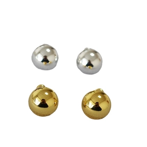 Polished gold and silver hemisphere stud earrings in a minimalist spherical design