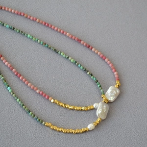 Detail of pink and turquoise beaded necklaces with baroque pearls and gold spacers