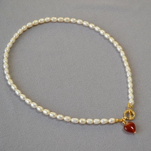 Elegant pearl necklace with red heart agate pendant and gold OT buckle closure