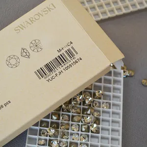 Macro detail of Swarovski crystal loose stones in golden hue and faceted round cut