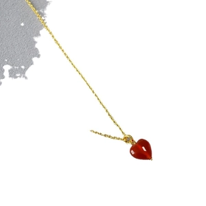 Elegant gold chain necklace featuring a polished red agate heart pendant for women