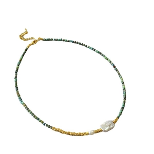 Vintage necklace with turquoise beads, golden metal spheres and a baroque pearl pendant