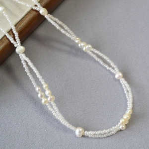Double-layered baroque pearl necklace with white seed beads in a French minimalist style