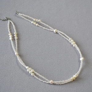 Macro detail of French baroque pearl double layer necklace with handcrafted gold clasp