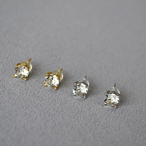 Macro view of sterling silver stud earrings with sparkling crystals and silicone backings