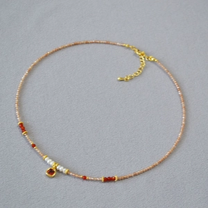 Minimalist freshwater pearl necklace with champagne zircon beads and a red square pendant