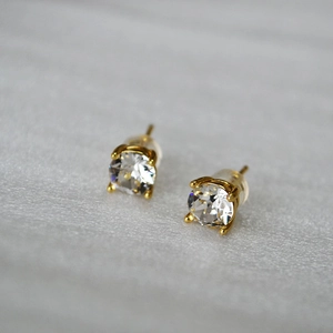 Detail view of 925 silver stud earrings with four-prong set sparkling crystals