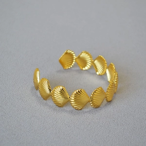 Golden shell-textured open bangle with a vintage marine design and polished finish