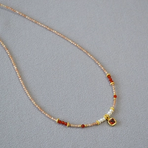 Elegant champagne zircon and freshwater pearl beaded necklace with red gemstone pendant