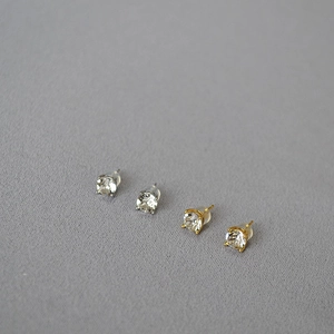Close-up of sparkling round crystal stud earrings in silver and gold plated finishes