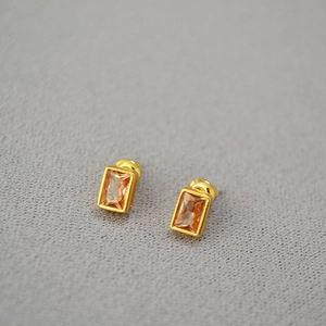 Macro shot of rectangular amber crystal earrings with gold plated 925 silver settings