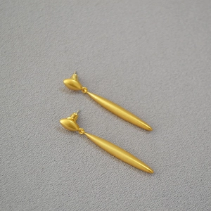 Minimalist long shuttle shaped matte gold drop earrings in an elegant french style
