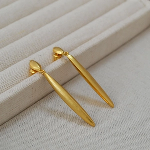 Elegant gold-plated brass long leaf drop earrings with a matte brushed finish on jewelry box