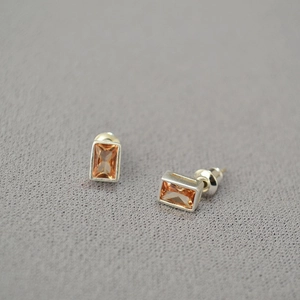 Detailed view of amber step-cut rectangular crystal earrings with 925 silver studs