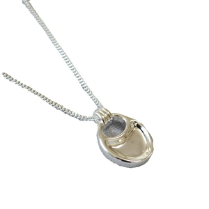 Silver pull-tab saddle bag necklace with minimalist industrial design on a white background