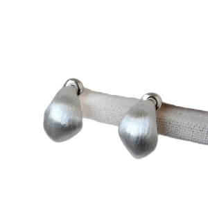 Minimalist brushed silver teardrop stud earrings with textured matte metallic finish