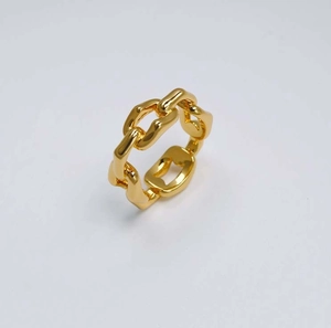 Vue détaillée macro de la bague à maillons en laiton plaqué or sur un fond blanc pur