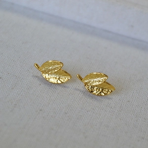 Detailed close-up of gold-plated leaf earrings showing fine textured veins and 925 silver pins