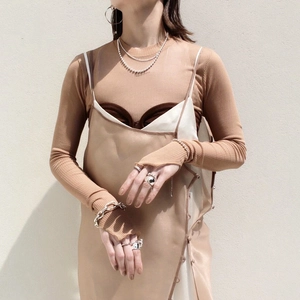 Bohemian double-layer pearl necklace styled with elegant silver rings and silk dress