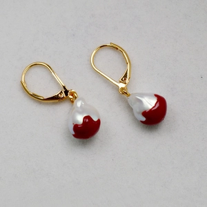 Detail of gold lever-back earrings with baroque pearls and red fluid enamel accents