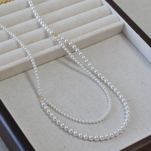 Double-layer bohemian pearl necklace with polished round white beads and gold clasp