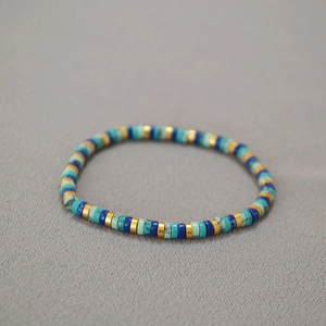 Bohemian heishi beaded bracelet with turquoise and gold discs in a flat stretch design