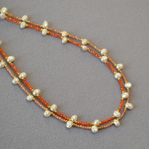Elegant baroque pearl and faceted orange stone beaded necklace with gold spacer beads