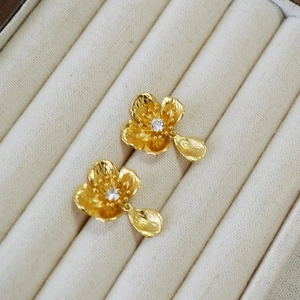 French vintage gold flower earrings with matte texture and sparkling center gemstone