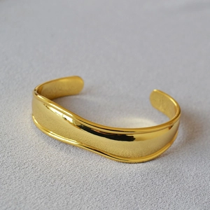 Minimalist irregular wave gold-plated brass cuff bracelet with a high polished mirror finish