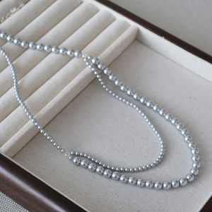 Detail view of Bohemian double-layered faux pearl necklace with lobster clasp and chain